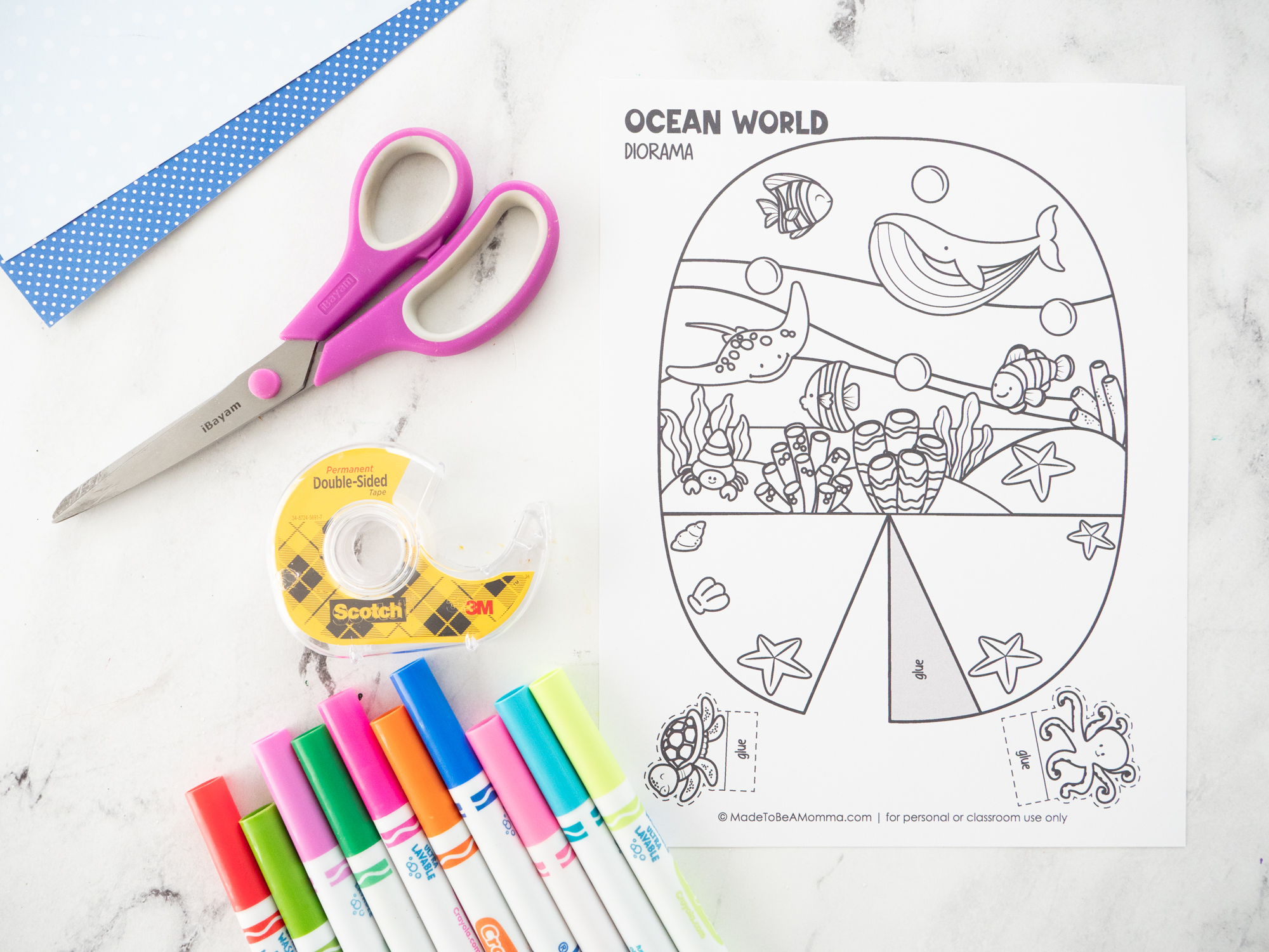 Supplies needed to make an Ocean Diorama for Kids including the printable template, markers, scissors, and cardstock.