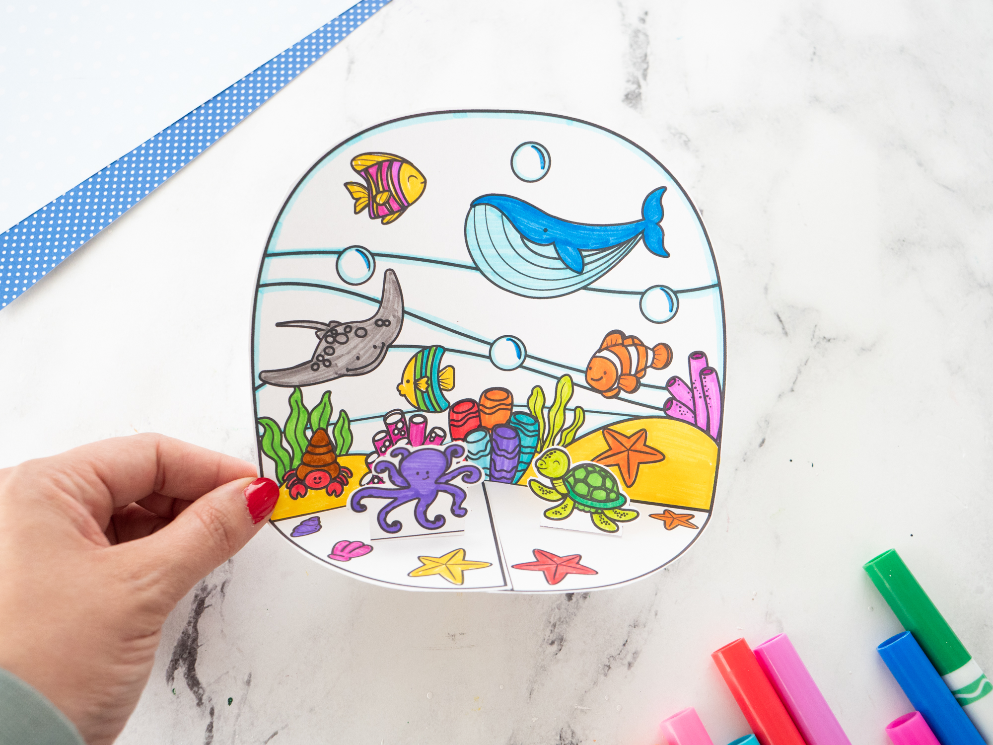 Place the ocean animals into the completed Ocean Diorama for Kids to finish the underwater display.
