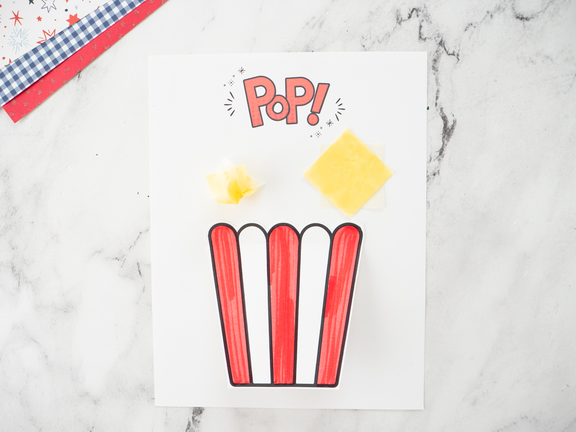 Layering tissue paper squares to create fluffy popcorn for the Carnival Popcorn Craft for Kids.