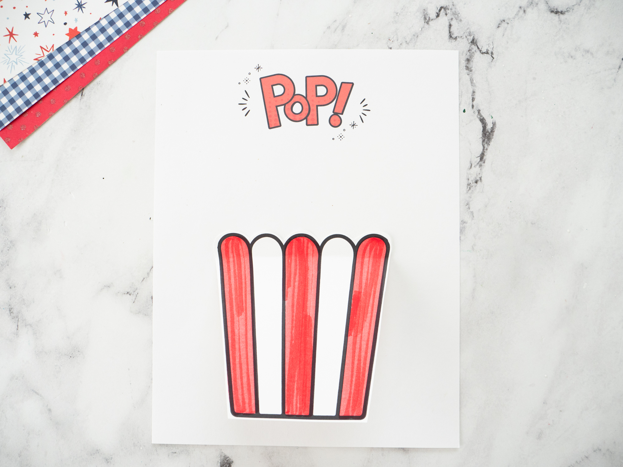 Cutting out the popcorn bucket and golden ticket pieces for the carnival popcorn craft.