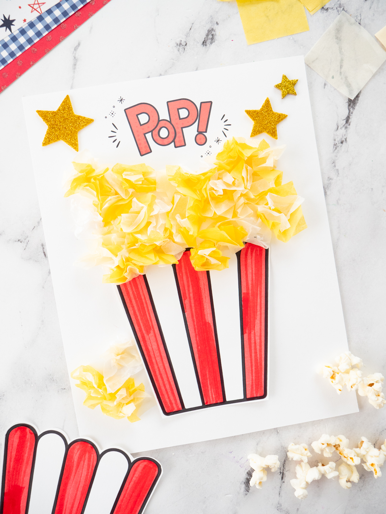 Carnival Popcorn Craft for Kids made with fluffy tissue paper popcorn and a hidden golden ticket printable.
