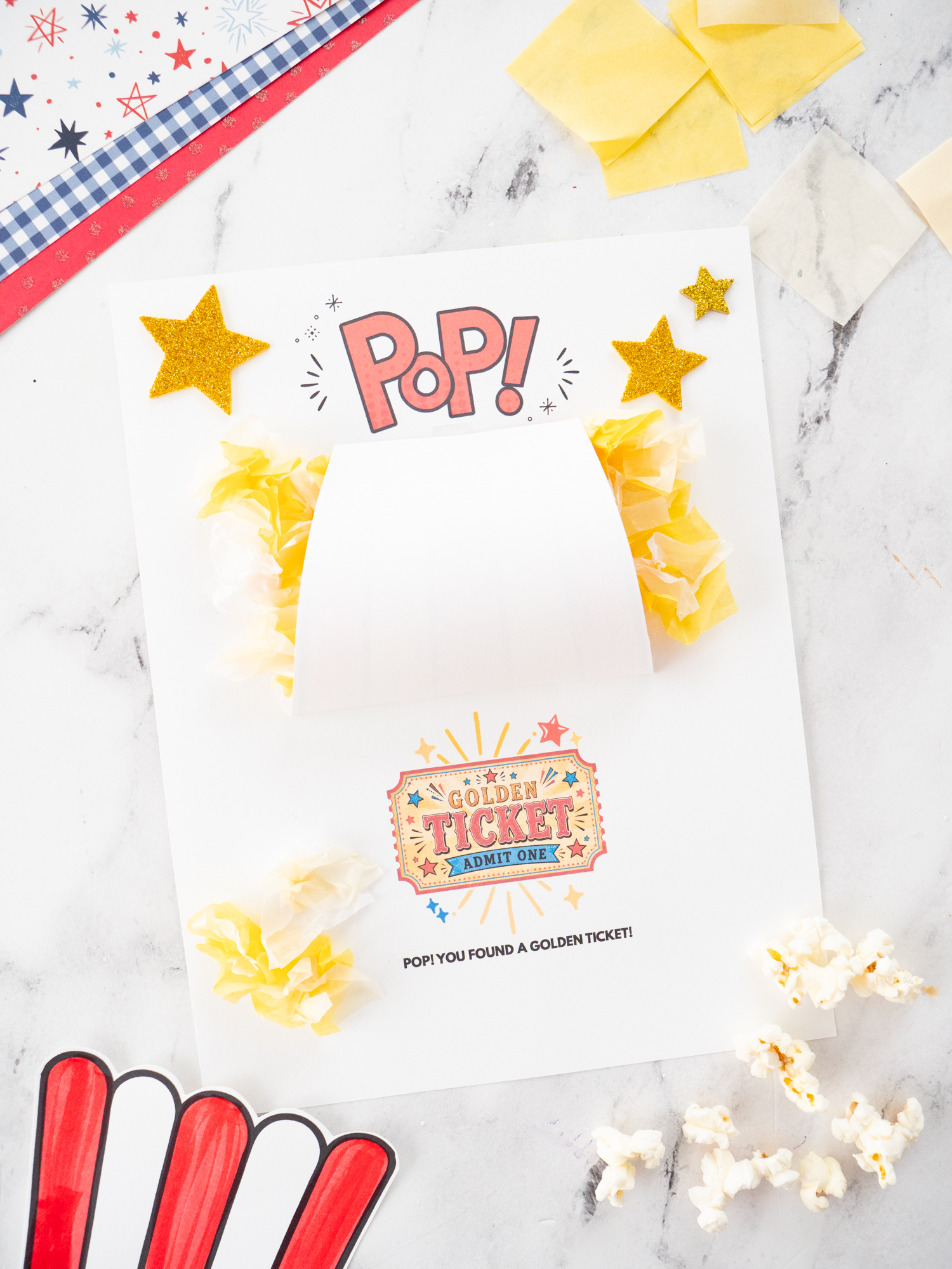 Finished Carnival Popcorn Craft for Kids with fluffy tissue paper popcorn and a hidden golden ticket.