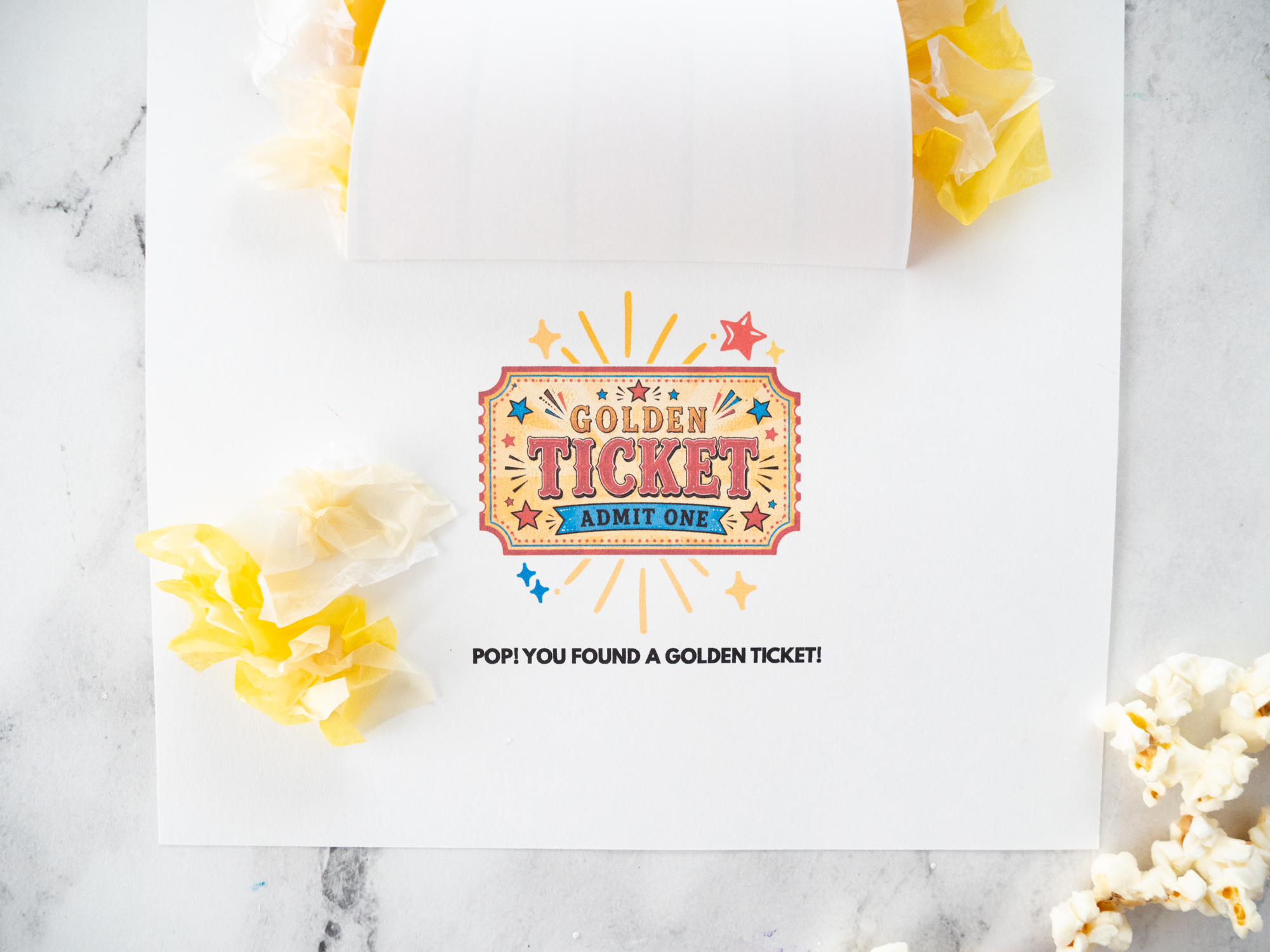 Lifting the popcorn bucket flap to reveal the hidden golden ticket underneath.