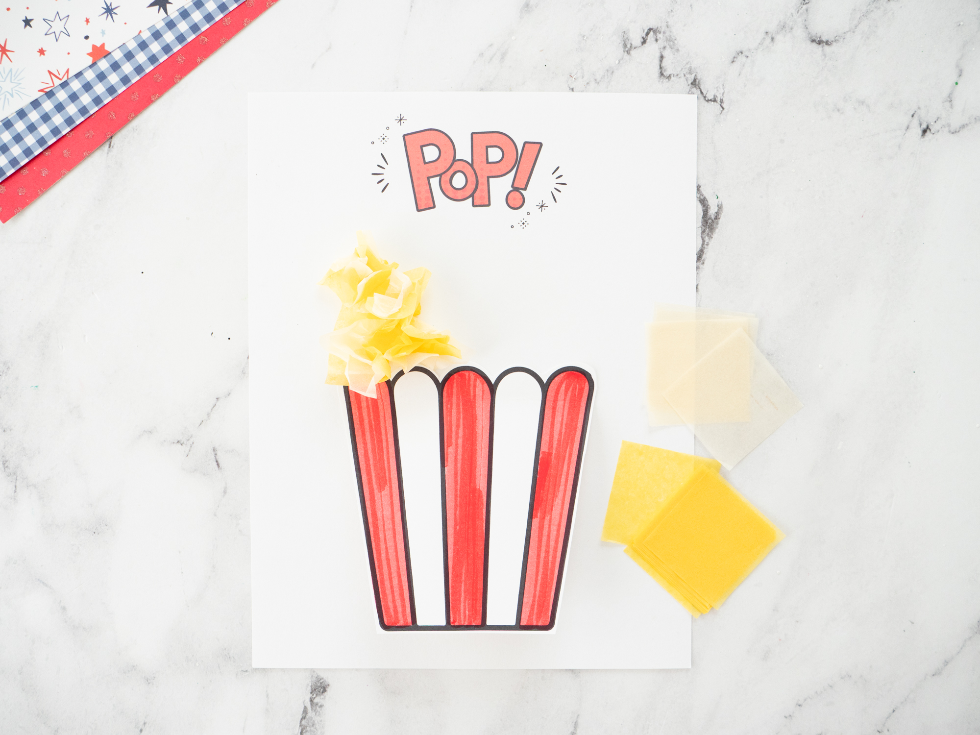Layering tissue paper squares to create fluffy popcorn for the Carnival Popcorn Craft for Kids.