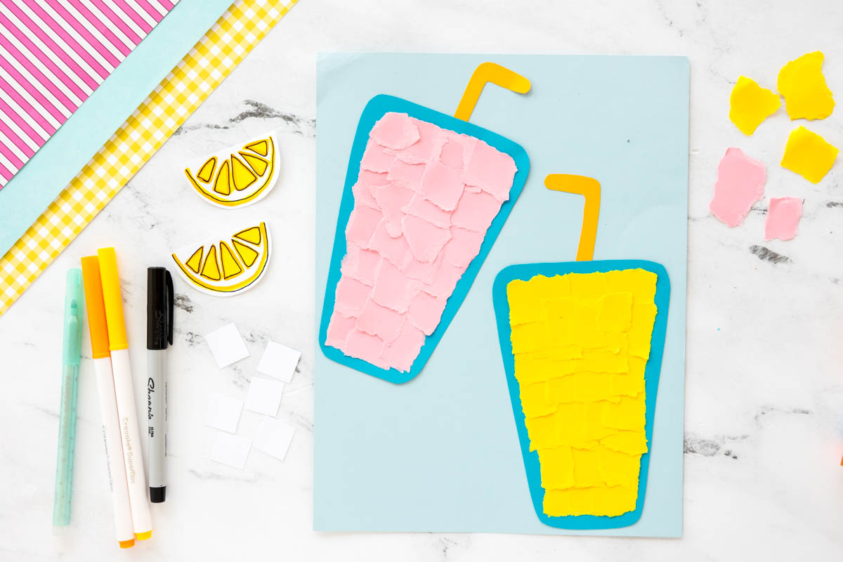 Child tearing yellow and pink paper into small pieces for a torn paper lemonade craft